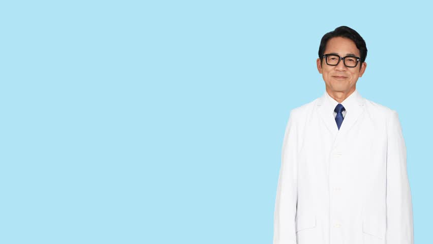A middle-aged Asian man in a white coat pointing at blank space in front of a blue background. Medical doctor. Scientist.