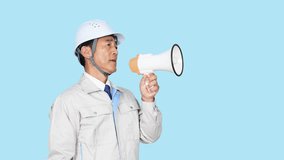 Asian middle-aged man wearing work clothes shouting through a bullhorn in front of a blue background. Factory worker. Construction engineer. - Powered by Shutterstock - Get 15% off with code: PIKWIZARD15