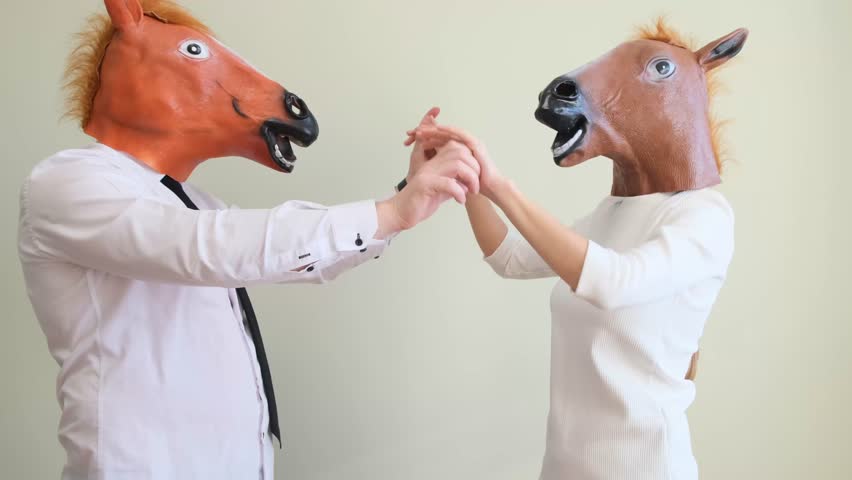 Family couple in latex horse mask dancing funny at home