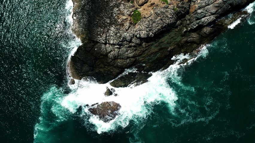 Aerial view Drone camera of seashore rocks in ocean, Beautiful sea surface, Amazing sea waves crashing on rocks seascape in Phuket island Thailand, Aerial view drone 4k High quality footage Royalty-Free Stock Footage #1111082639