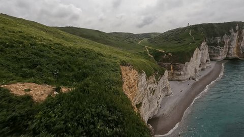 Aerial drone view of FPV First Person View drone mountain surfing at the cliffs of Normandy and the coastline.: film stockowy