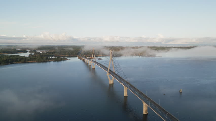 Stunning aerial vista over finnish nature, mirror-like water and vast forest. Replot Bridge in foreground. Vaasa, Finland