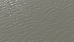 Water surface With a small wave, waves on the pond surface. Waves in shallow water aerial view. Flying over the muddy water, along the shore. Slow motion video, 10 bit ungraded D-LOG