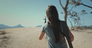 Travel blogger woman shooting on camera beautiful mountain landscape. Girl walk hold record on gopro, back view. Outdoor lifestyle travel on summer holiday vacation. Pai Canyon Chiang Mai , Thailand.