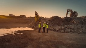 Aerial Drone Shot Of Construction Site With Excavators On Sunny Day: Diverse Team of Real Estate Developers Discussing Project. Civil Engineer, Architect, Inspector Talking And Using Tablet Computer. - Powered by Shutterstock - Get 15% off with code: PIKWIZARD15