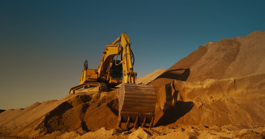 Construction Site On A Hot Sunny Day: Industrial Excavator Digging Sand To Lay Foundation for Building New Apartment Block. Workers Operating Heavy Machinery To Complete A Real Estate Project. Royalty-Free Stock Footage #1111090565