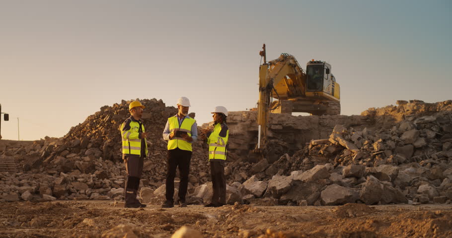 Construction Site With Excavators on Sunny Day: Diverse Team Of Male And Female Specialists Discussing Real Estate Project. Civil Engineer, Architect And Investor Talking About New Apartment Building. Royalty-Free Stock Footage #1111090631