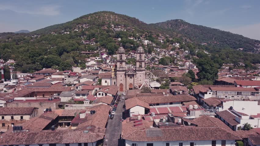 Drone hovering between the bell towers of the Parish of San Francisco de Asís, the church located in the town of Valle de Bravo, State of Mexico