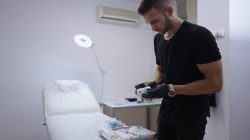 Muscular doctor prepares the material for a serotherapy session