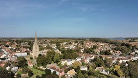 Aerial view of Thaxted church and titling down. Thaxted is a popular town in Essex, UK, famous for its traditional architecture, bucolic English scenery and numerous cultural festivals.