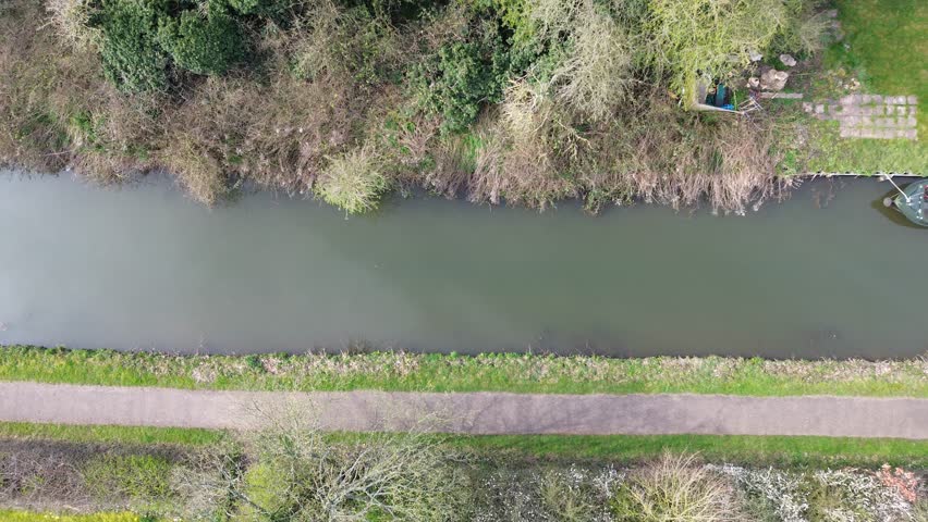 An aerial view of narrowboats parked in a river