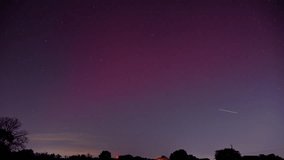 Long exposure time lapse of a Stable Auroral Red arc, or SAR arc, a rare space phenomenon over north east Oklahoma sky on November 5th, 2023.  - Powered by Shutterstock - Get 15% off with code: PIKWIZARD15