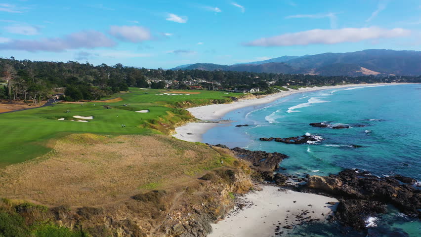 Drone shot low over the Pebble beach, sunny day in Monterey, California, USA