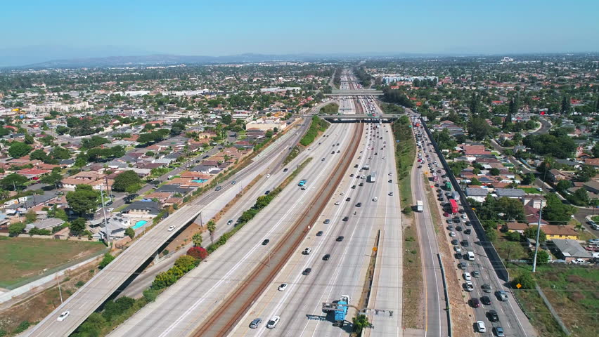 Aerial drone following traffic driving down 710 Interstate in Los Angeles, California