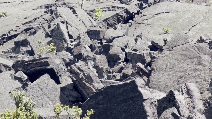 Cinematic close-up panning shot of mounds of dried lava rock along the Kilauea Iki trail in Hawai