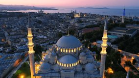 Old city of Istanbul over Suleymaniye Mosque in Ramadan. Drone flies over illuminated Süleymaniye Mosque in early morning. Hagia Sophia, Blue Mosque, Beyazıt Tower in background against Marmara Sea - Powered by Shutterstock - Get 15% off with code: PIKWIZARD15