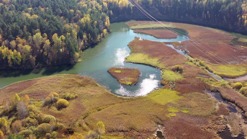 Aerial video of meanders of the Koen river. Beautiful autumn landscape from above. Novosibirsk, Siberia, Russia
