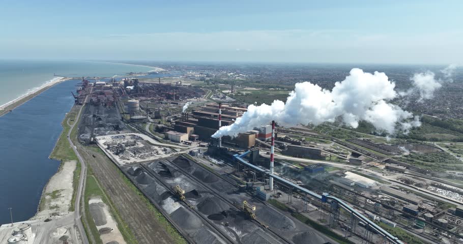 A large iron and steel factory in the town of Groot Sinten Grande Synthe, near Dunkirk, France. It is an integrated iron and steel company with blast furnaces, steel mills and rolling mills covering a | Shutterstock HD Video #1111121549