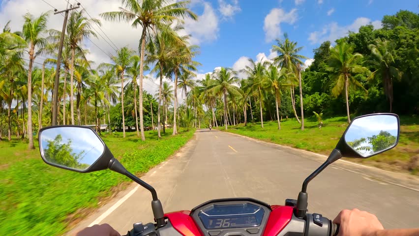 Riding a scooter on a tropical island in Thailand. POV