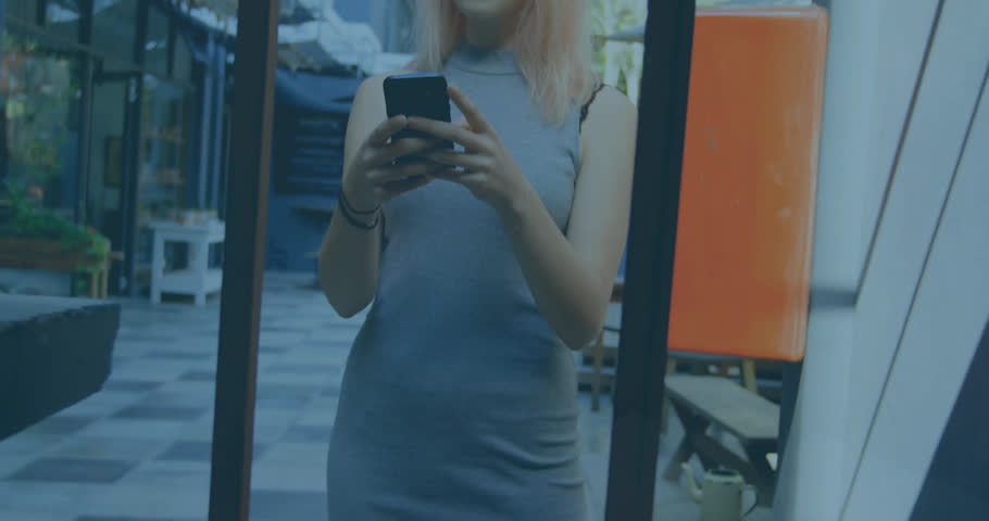 Animation of graphs with changing numbers over smiling caucasian woman chatting using cellphone. Digital composite, multiple exposure, report, business, growth and technology concept.