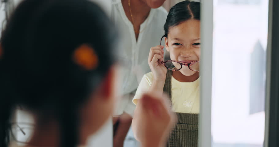 Mirror, child and choice for glasses, smile and eye care for healthcare, reflection and decision for eyewear. Happy girl, medicare and excited for frame, optometry and consulting or wellness vision