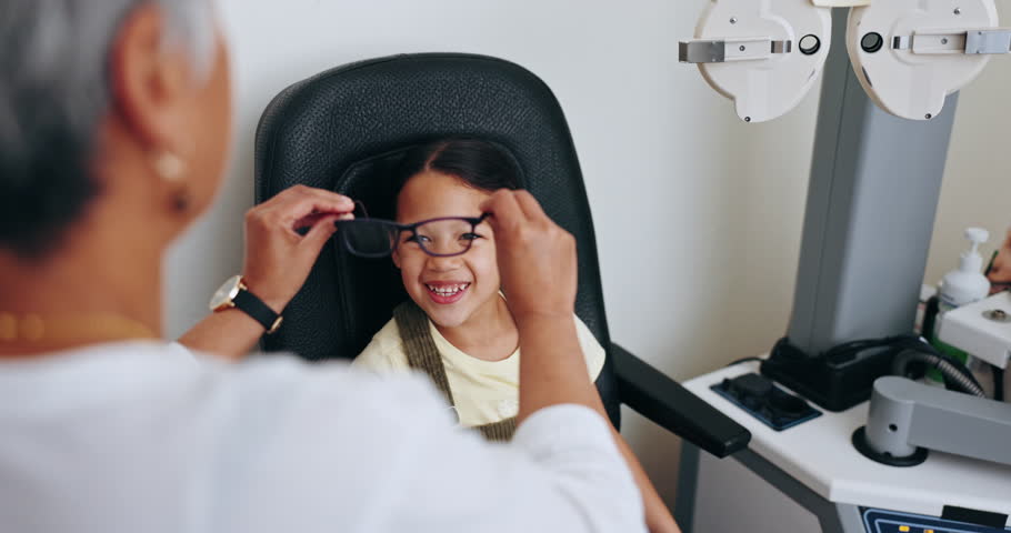 Optometrist, child and frame for glasses, smile and eye care for healthcare, assessment and decision for eyewear. Happy girl, medicare and excited for choice, optometry and consulting or wellness Royalty-Free Stock Footage #1111141855