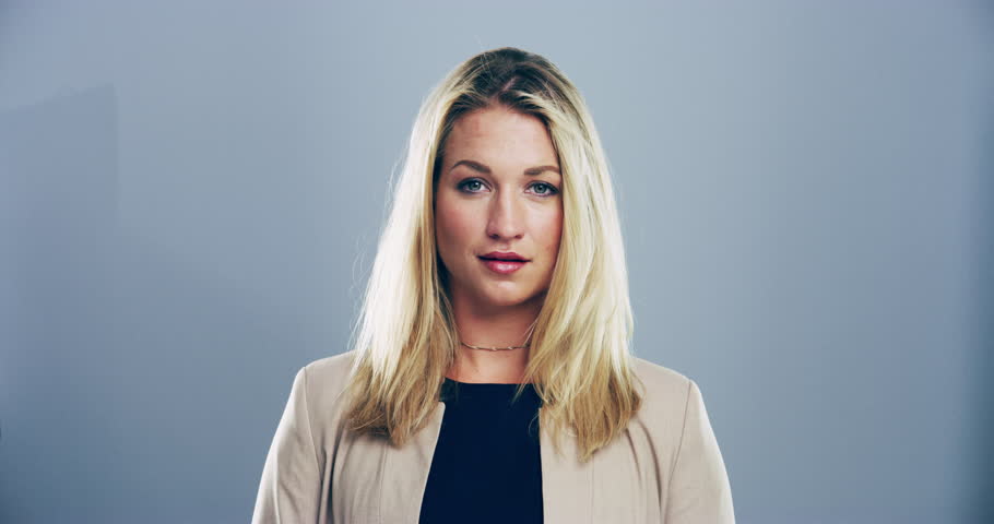 Face, smile and fashion with a blonde woman in studio on a gray background for style positivity. Portrait, happy and trendy with a young person in a good mood in a clothes outfit for carefree joy