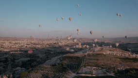 Balloons flying over Cappadocia during sunrise, aerial view, drone video 4K