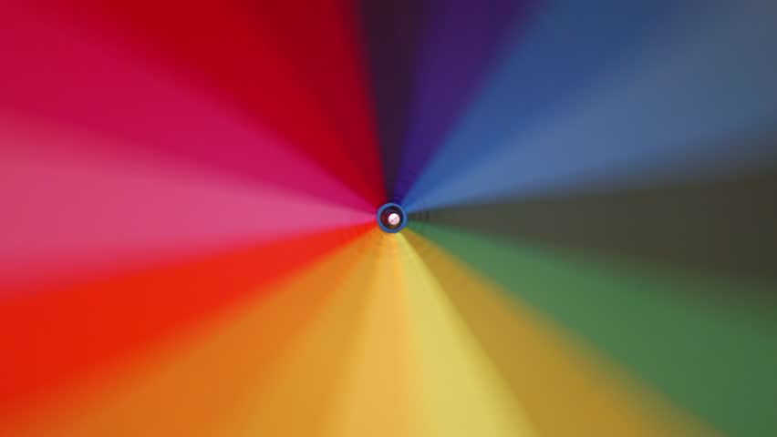 Multi-colored rainbow umbrella rotates around its axis, 4k