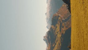 Panorama of Swiss Alps in Autumn, vertical video. Fall in Switzerland with snowy mountains on horizon. Beautiful Swiss landscape with colorful autumn trees. Travel destinations. Outdoor activities