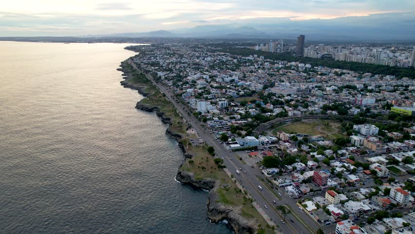 Aerial cinematic footage of the city of Santo Domingo, Capital Of Dominican Republic, its beautiful streets and buildings, la Fuente Centro de los Heroes, the Pabellón de las Naciones