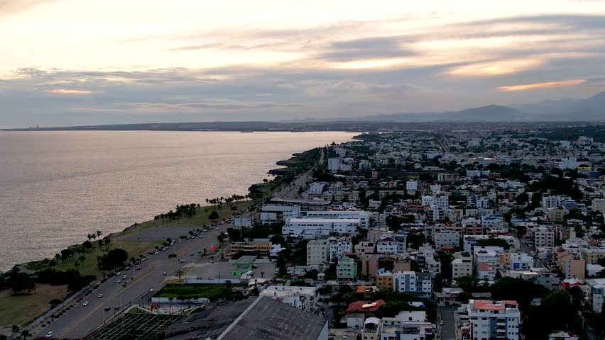 Aerial cinematic footage of the city of Santo Domingo, Capital Of Dominican Republic, its beautiful streets and buildings, la Fuente Centro de los Heroes, the Pabellón de las Naciones