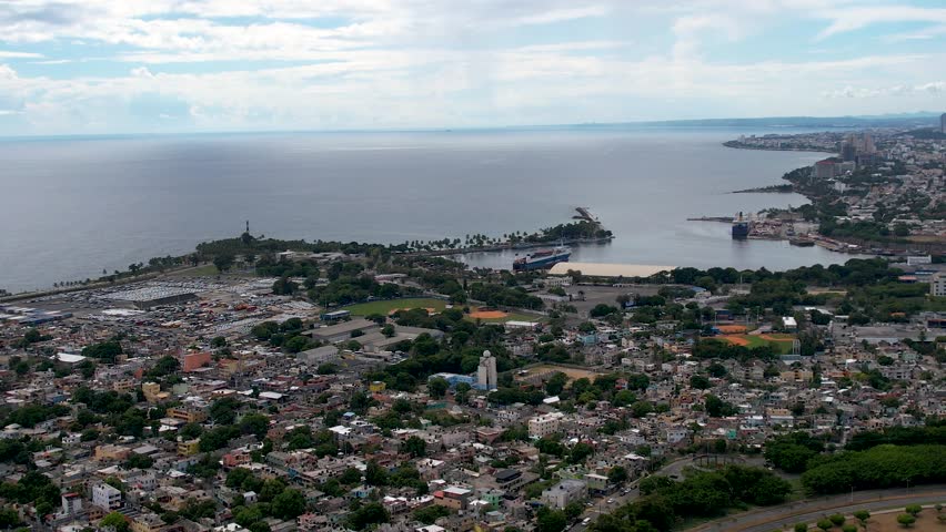 Aerial cinematic footage of the city of Santo Domingo, Capital Of Dominican Republic, its beautiful streets and buildings, la Fuente Centro de los Heroes, the Pabellón de las Naciones