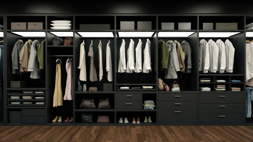 Luxury wardrobe, stylish clothes organised on shelves in a large walk-in closet interior. Royalty-Free Stock Footage #1111176181