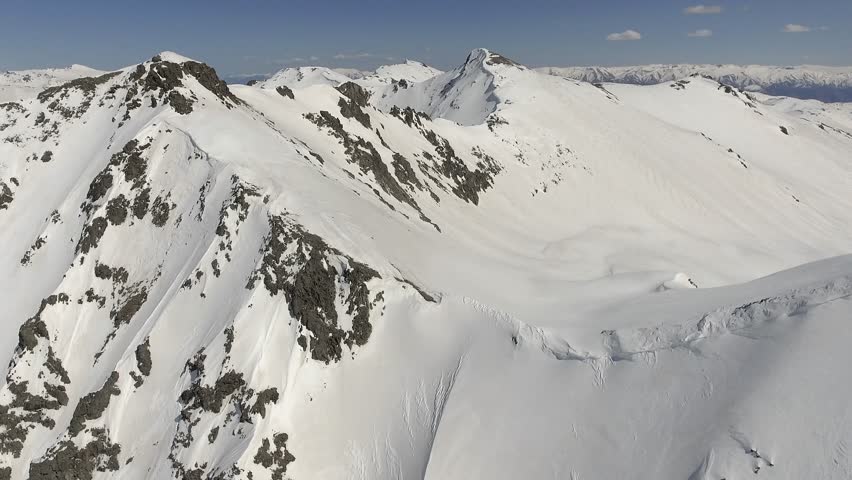 Aerial view of the snowy peaks of the Andes Andean mountain range in Patagonia Southern America. Royalty-Free Stock Footage #1111178109