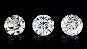 Round variously cut diamonds with different facet quantity rotating on black glossy background. 17, 57, 129 facets comparison.  Seamless loop 3d animation - Powered by Shutterstock - Get 15% off with code: PIKWIZARD15