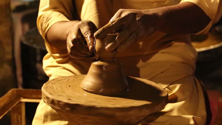 A Man Making clay pot on the pottery wheel , Selective focus, close-up, Pottery, hand work in Lok Virsa, Islamabad, Pakistan
