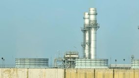 Aerial view of a massive power plant, its towering stacks emitting plumes of white smoke, surrounded by sprawling industrial infrastructure. Energy production sector vital for global growth. 4K.
 - Powered by Shutterstock - Get 15% off with code: PIKWIZARD15