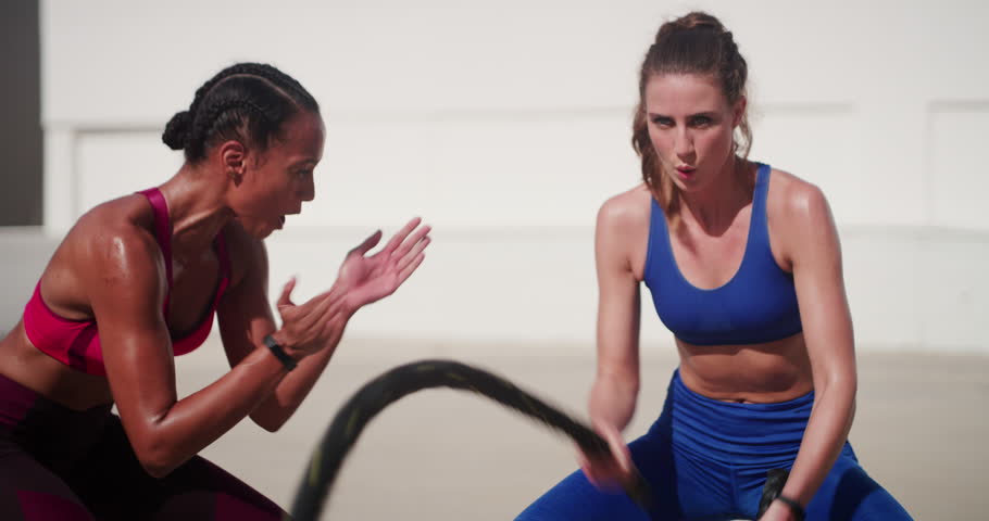 Personal trainer motivation, battle rope and woman in city, fitness or training healthy body. Workout, coach or exercise in street for power, strong muscle or energy, sport and clapping for challenge Royalty-Free Stock Footage #1111182659