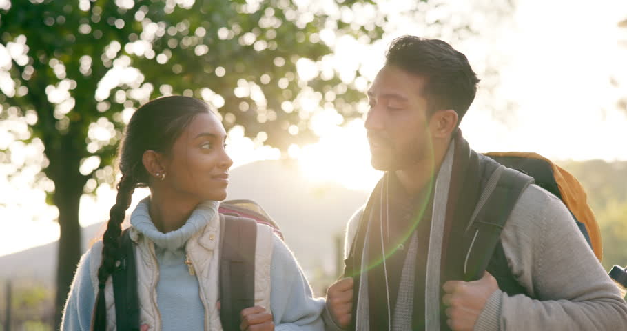 Hiking, fitness and couple in a forest talking, bond and having fun exploring nature together. Backpacking, love and conversation by woman and man in woods for hike, exercise or trekking adventure