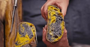 Homemade sourdough activated charcoal black bread with pumpkin oven baked and woman baker with autumn seasonal foods in kitchen video