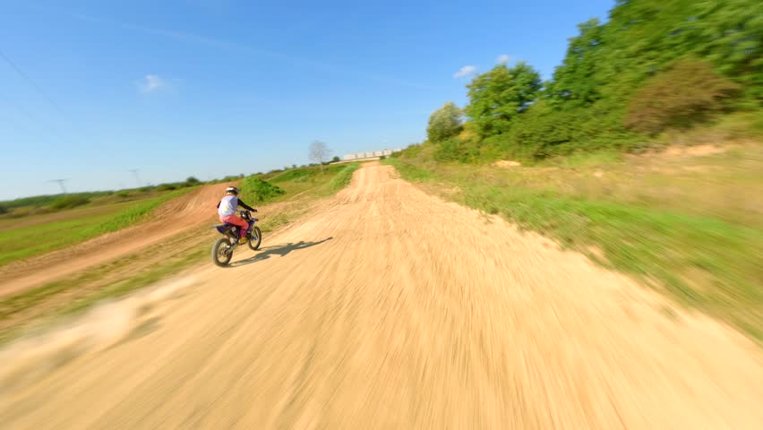 FPV of high-speed motocross bike on track. Concepts of extreme sports, racing, and adrenaline.