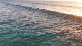 Slow motion of large waves of the Atlantic Ocean illuminated by sunset light. Cinematic drone of sunset over the sea. aerial view.