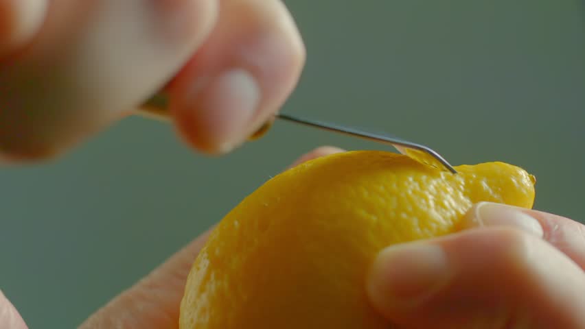 Man Peels Lemon Zest with Peeler