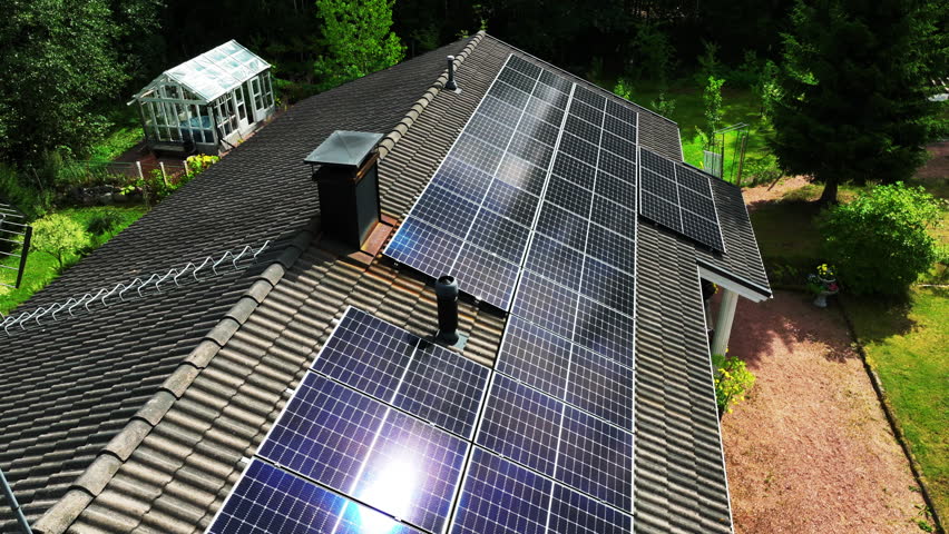 Aerial view around reflecting PV modules on a self-sufficient, off-grid house Royalty-Free Stock Footage #1111192947
