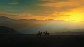 silhouette video of horses on the hill at sunset