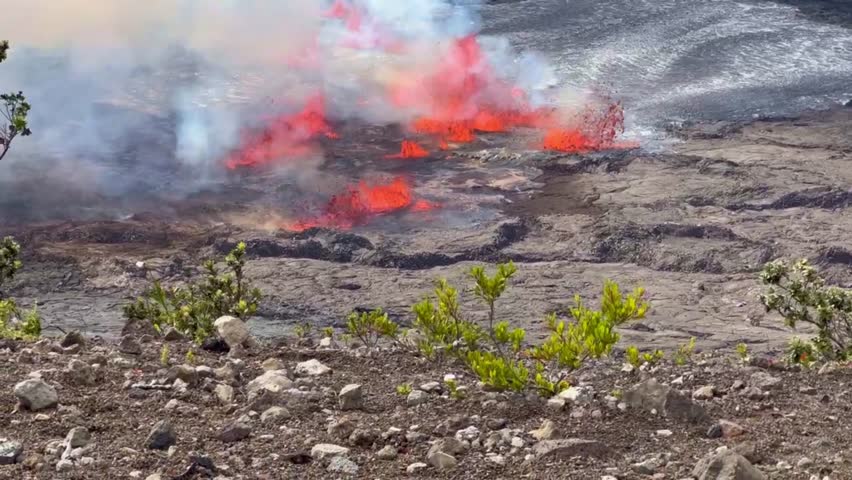 Cinematic long lens booming up shot of lava fountains spewing out of Kilauea Crater mere minutes after eruption began in September 2023 at Hawai