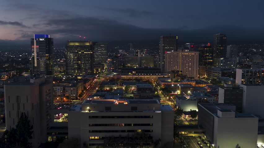 Establishing Aerial View Shot of Oakland at night evening CA, California, USA
