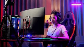 Asian Girl Streamer Having A Backache While Playing Game Over Network On Personal Computer. Live Stream Video Game, Desk Illuminated By Rgb Led Strip Light