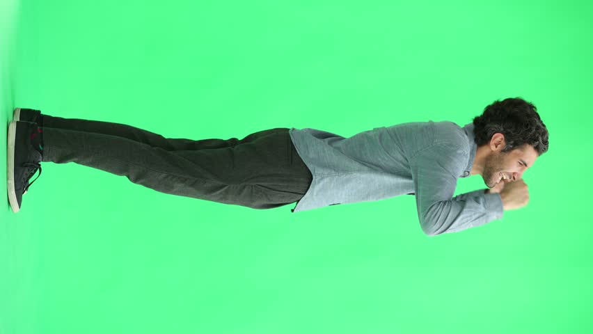 man in full growth. isolated on green background jumping rejoices